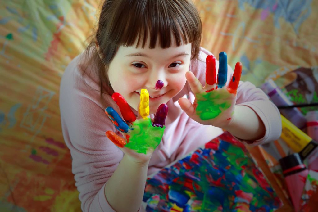 Cute little girl with painted hands